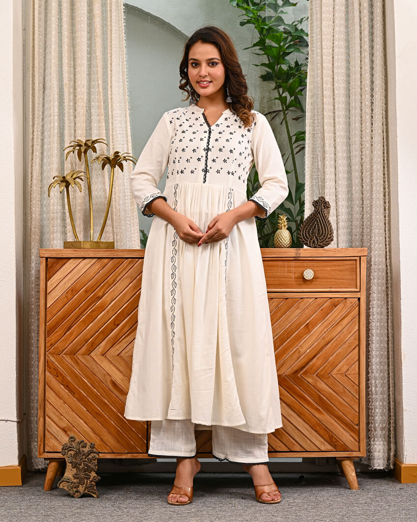Woman in a white traditional outfit with pant by indi inside