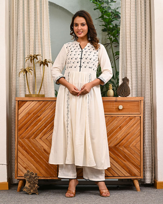 Woman in a white traditional outfit with pant by indi inside