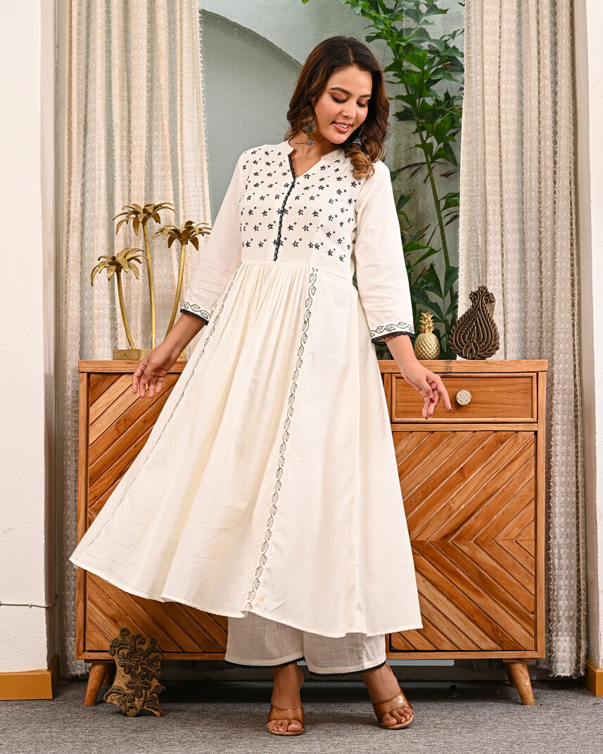 Woman in a white traditional Embroidery outfit with pant by indi inside