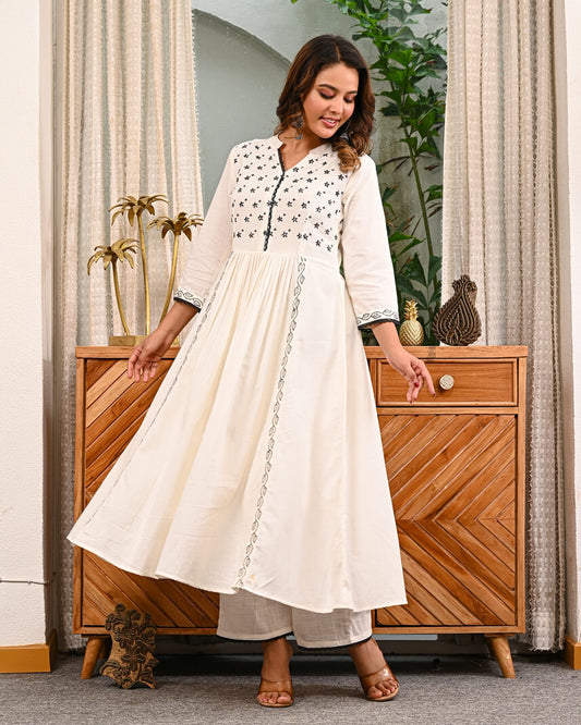 Woman in a white traditional Embroidery outfit with pant by indi inside
