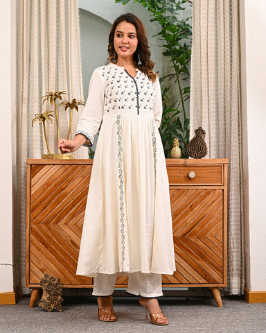 Woman in a white traditional Embroidery outfit with pant by indi inside