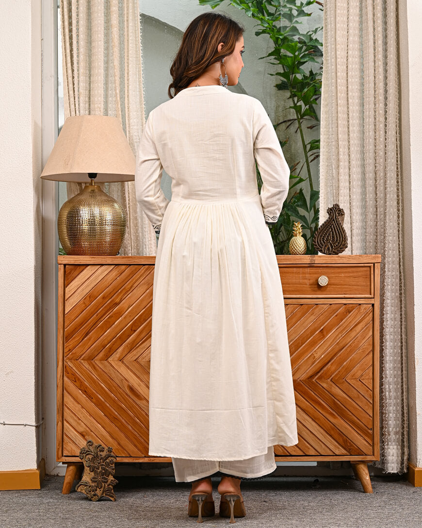 Woman in a white traditional Embroidery outfit with pant by indi inside